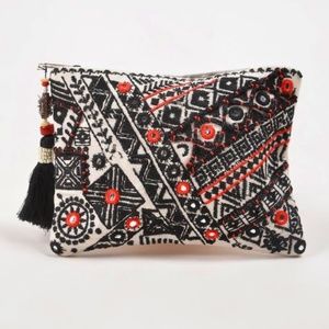 Hand embroidered mirrorwork clutch with tassel